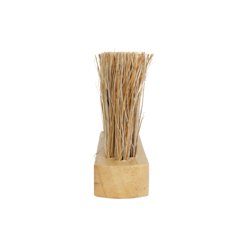 Top view of the Sande wooden sand removal brush with natural coconut and jute bristles on a white studio background.