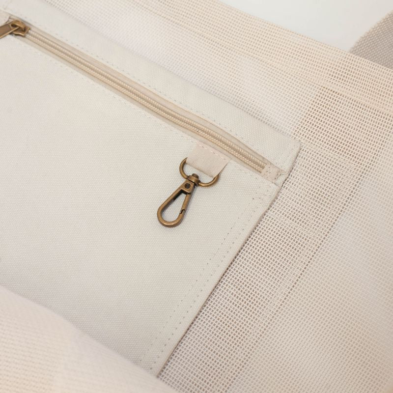 Close-up image of the Sande Kids Beach Hauler™ showcasing the durable canvas pocket and brushed bronze key clip, designed for convenient organization of beach essentials.