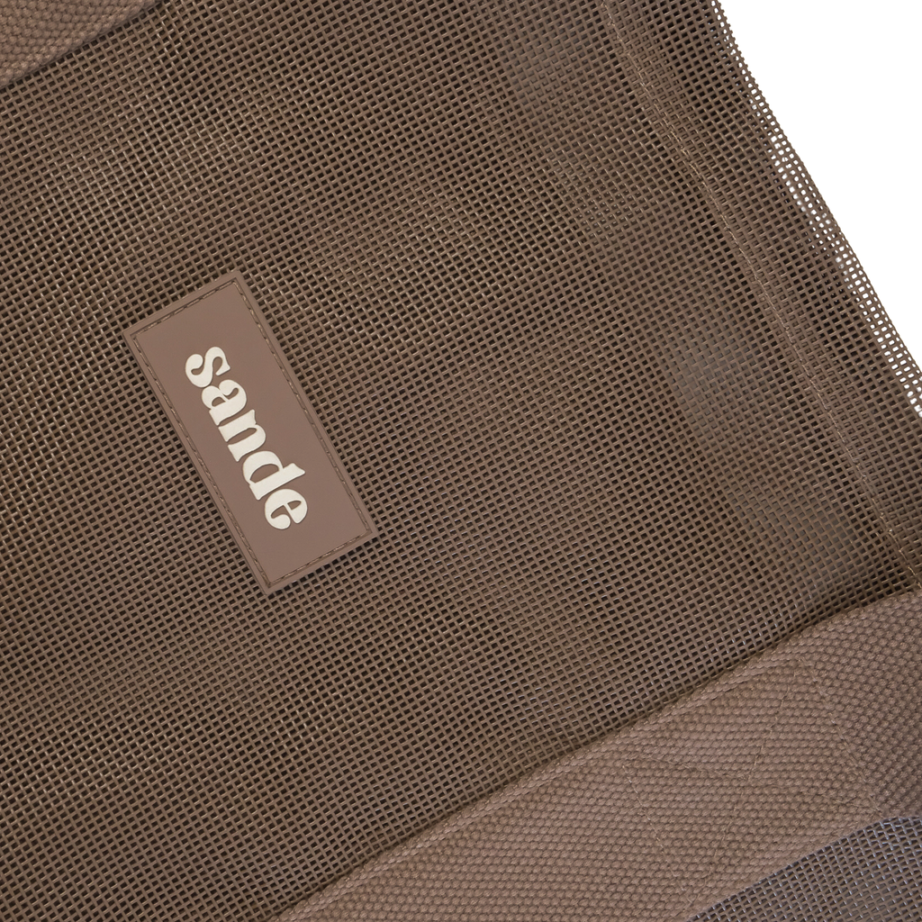 Close-up image of the Sande Kids™ Beach Hauler oversized mesh bag in Espresso Brown, highlighting the durable mesh fabric, thick cotton straps, and silicone Sande logo. Perfect for carrying beach essentials on family beach days, market trips, and outdoor adventures.
