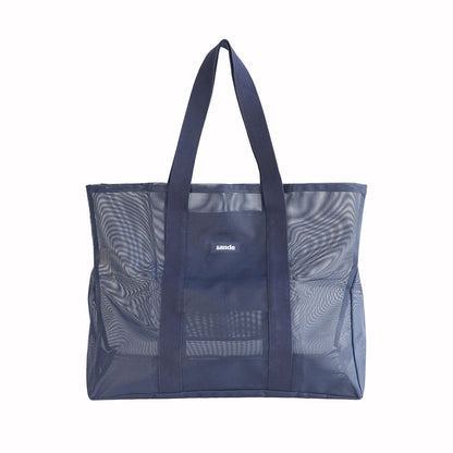 Oversized Sande Beach Hauler mesh beach bag in Deep Sea Navy, displayed in a studio setting. Shown front-on to highlight the mesh detail, thick cotton straps, and silicone Sande Kids logo. Set against a white background.
