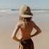 A little boy at the beach, with the ocean in the background, standing with his hands on his hips. He’s wearing the Sande Kids™ cap on backwards, showcasing the embroidered Sande logo.
Cap is lightweight, fast-drying nylon. Perfect for outdoor adventures.