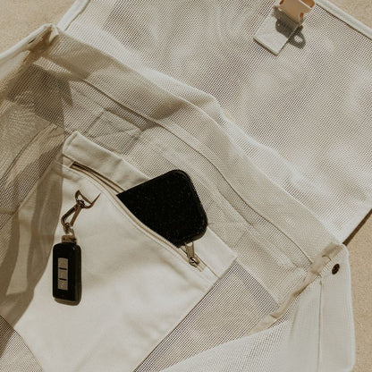 Close-up of the internal secure canvas pocket and key clip in the Sande Kids Beach Hauler mesh backpack, designed to keep valuables safe.