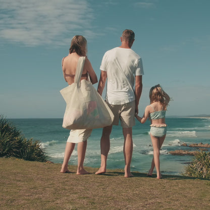 Video showcasing a family enjoying a day at the beach with the oversized Sande Kids Beach Hauler mesh beach bag, the original mesh beach bag designed for easy carrying and large capacity, perfect for fun beach days with family.